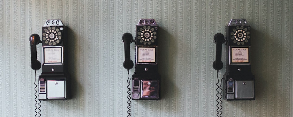 wall mounted phones with dials.